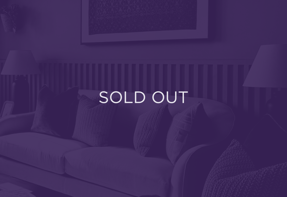 an image of a sofa, with a purple overlay and text that says sold out