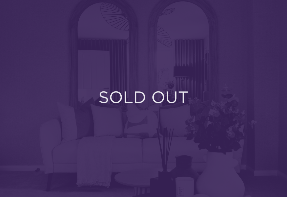 an image of a sofa in front of mirrors, with a purple overlay and text that says sold out