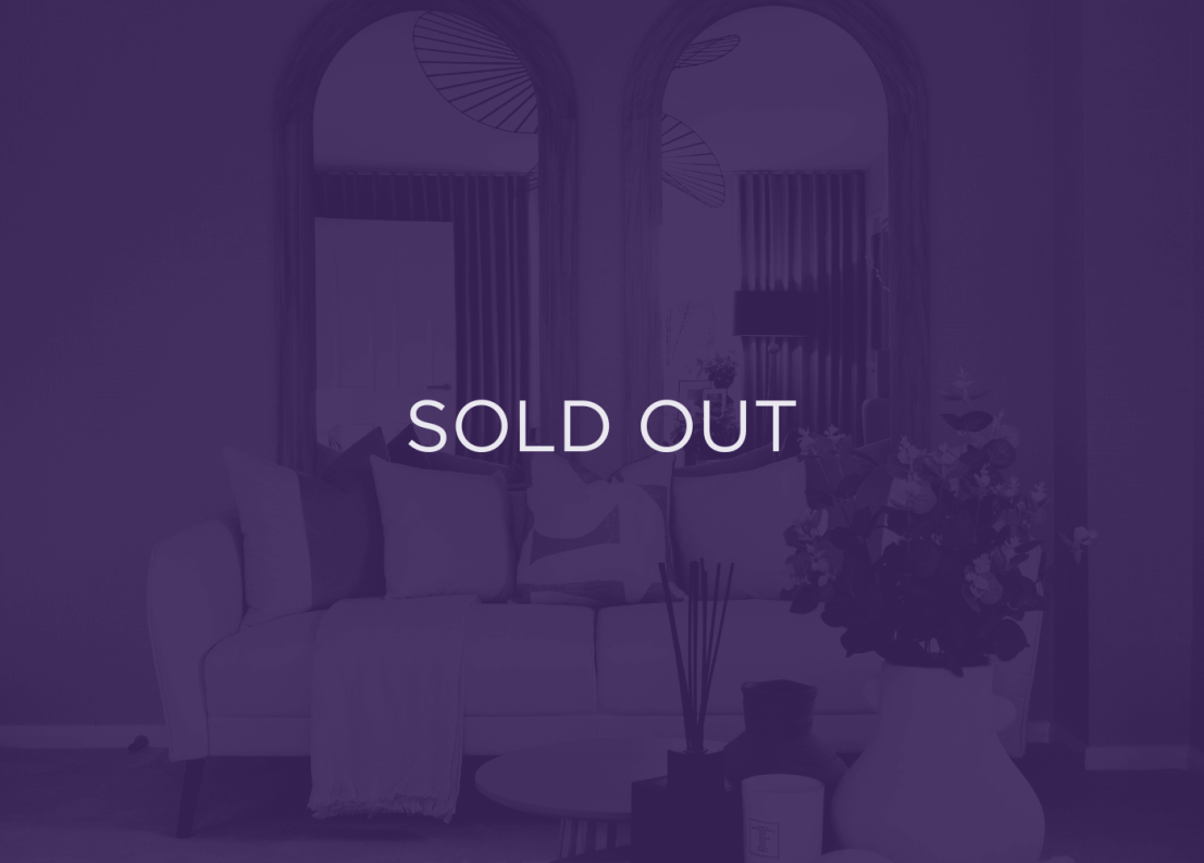 an image of a sofa in front of mirrors, with a purple overlay and text that says sold out